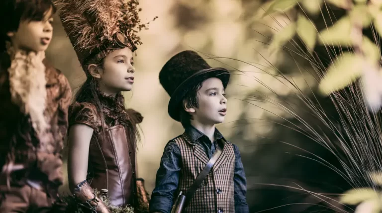 Three children wearing elegant steampunk Victorian clothing watch something with curiosity in a peaceful woodland setting.